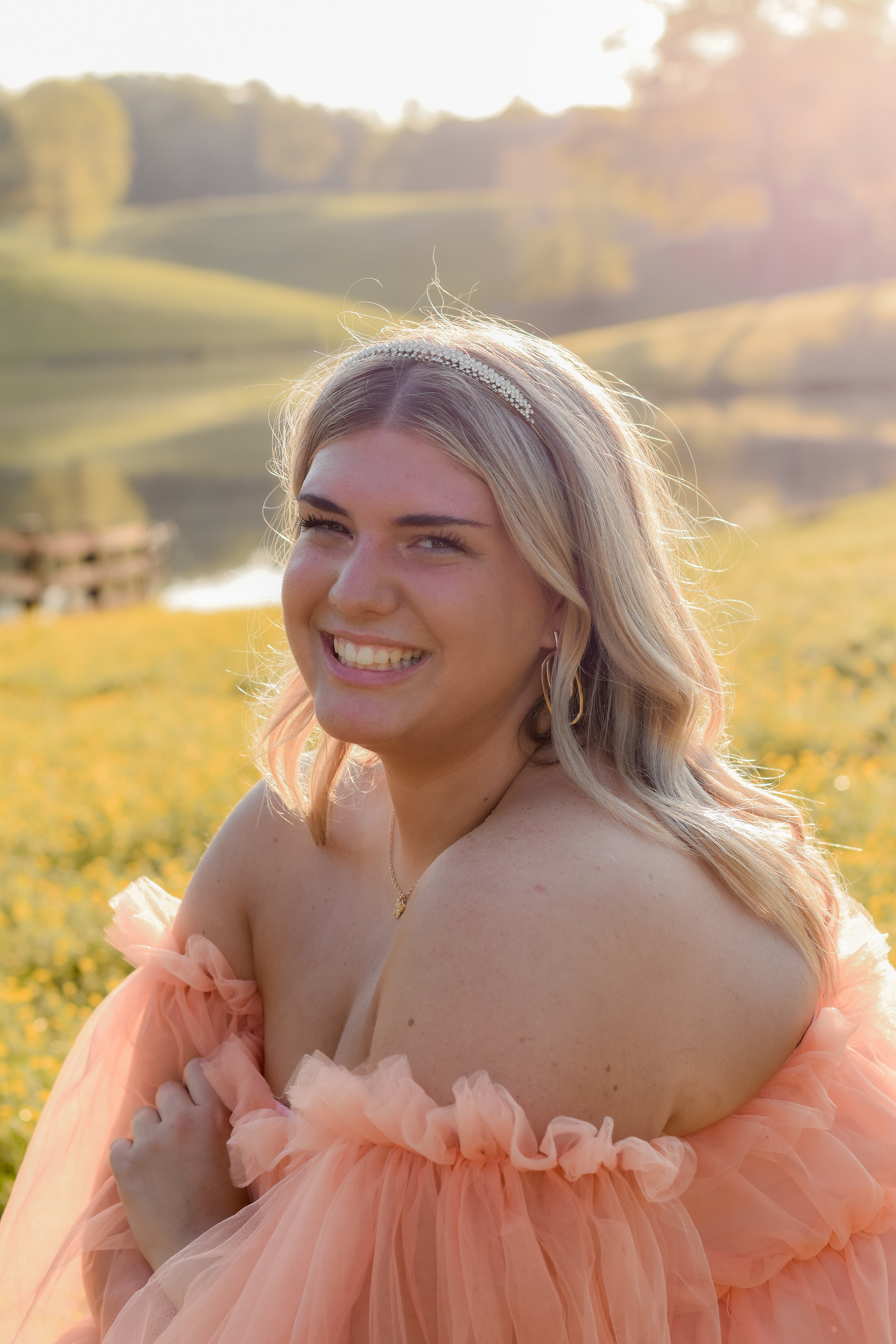 Girl in light pink dress in sunny feild
